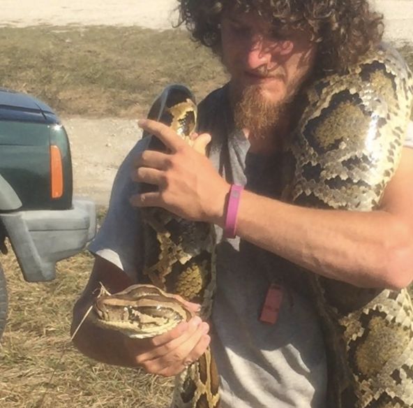 Daniel Moniz is seen holding one of his catches during the Python Challenge in the Florida Everglades.