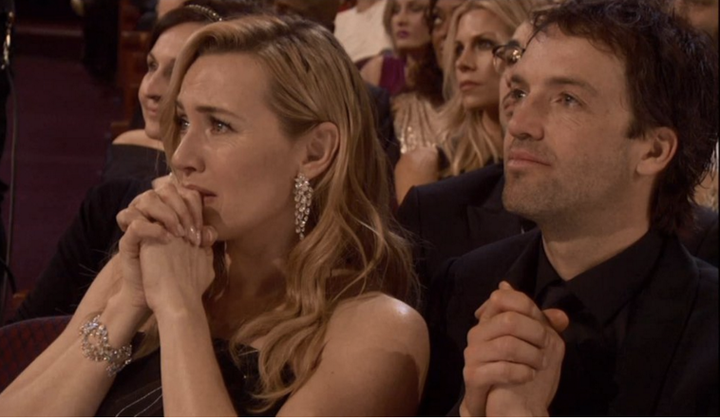 Kate Winslet reacts to Leonardo DiCaprio's Oscar win.