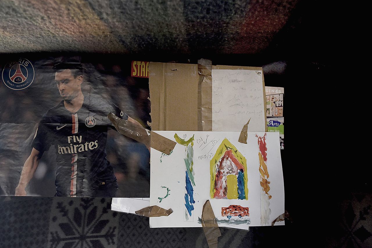 The images are "grubby and bleak because that is the reality of what life is like there," Turner said. This photo was taken inside the home of Ahmad, who had lived in Calais for three months when the photo was taken.