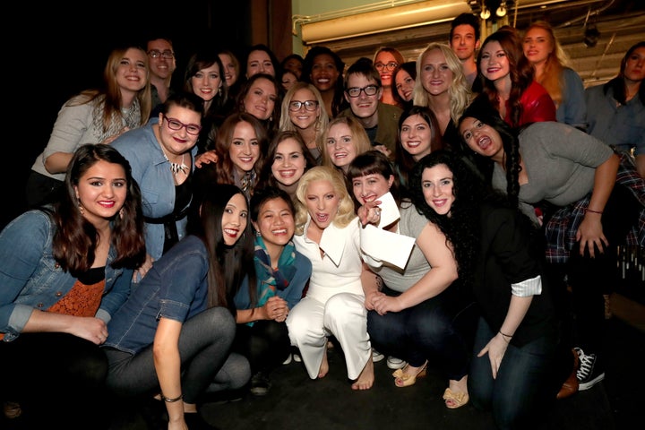 Lady Gaga poses backstage with sexual assault survivors who joined her during her performance at the 88th Academy Awards on Sunday.