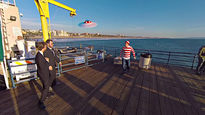 Two suited sleuths are seen cornering Waldo after tracking him down on the Santa Monica pier in the "Where's Waldo?" 360-vide