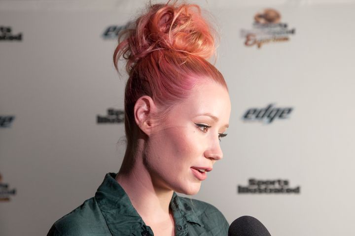Rapper Iggy Azalea is interviewed on the red carpet at the Sports Illustrated Friday Night Party on February 5, 2016 in San Francisco, California.