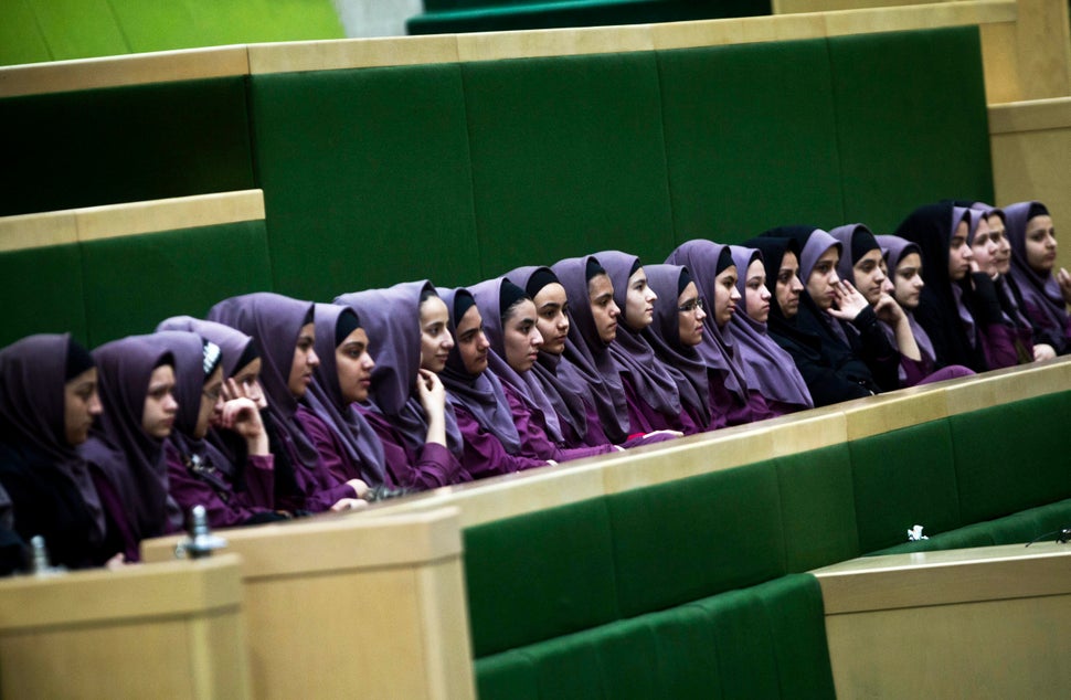 Iranian school girls observe Members of Parliament discussing a draft to limit photographer's and cameramen's access to cover