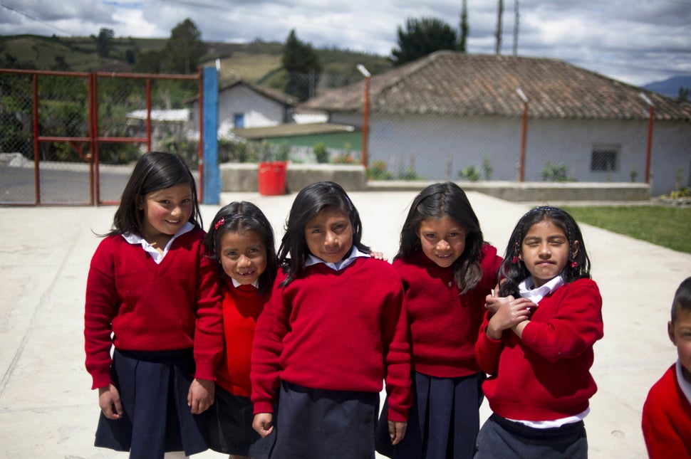 Girls pose at a rural school at La Palizada in Tulcan, Carchi province, in Ecuador close to the Colombian border on November 