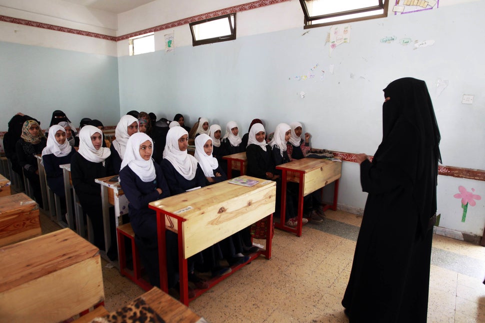 Yemeni girls listen to their teacher on their fist day of school at a public institution in the Yemeni capital Sanaa on Novem