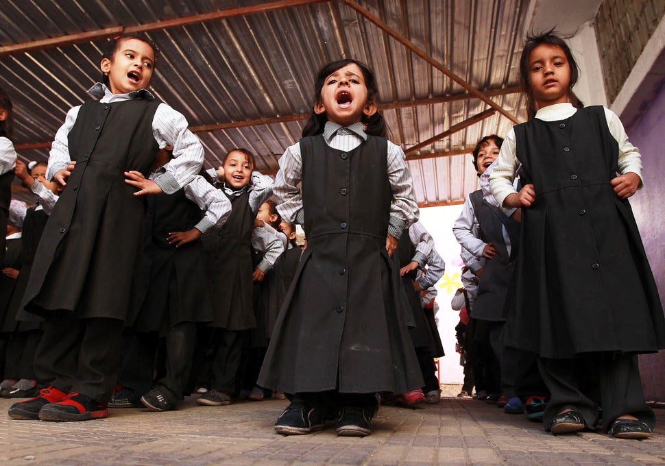Yemeni schoolgirls attend an anti-mine and unexploded ordnance awareness campaign in a school in Sanaa on December 17, 2014. 