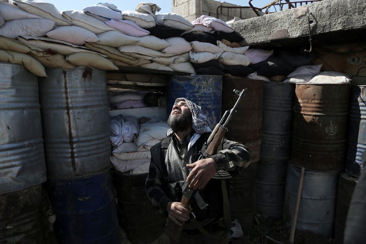 A Syrian rebel fighter from the Failaq al-Rahman brigade mans a position on the frontline against Syrian government forc