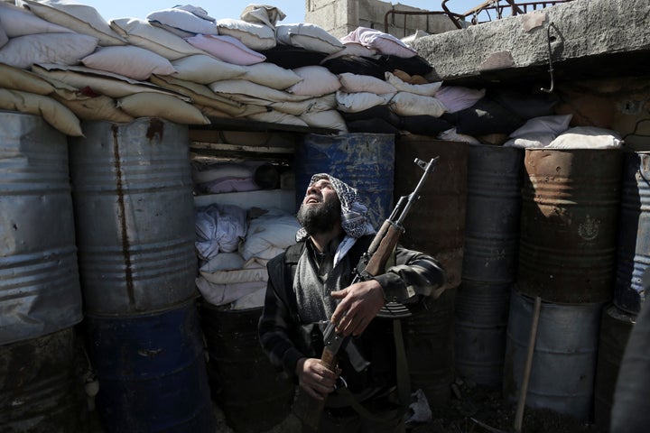 A Syrian rebel fighter from the Failaq al-Rahman brigade mans a position on the frontline against Syrian government forces in the town of Arbin on the outskirts of the capital Damascus on Feb. 26, 2016.