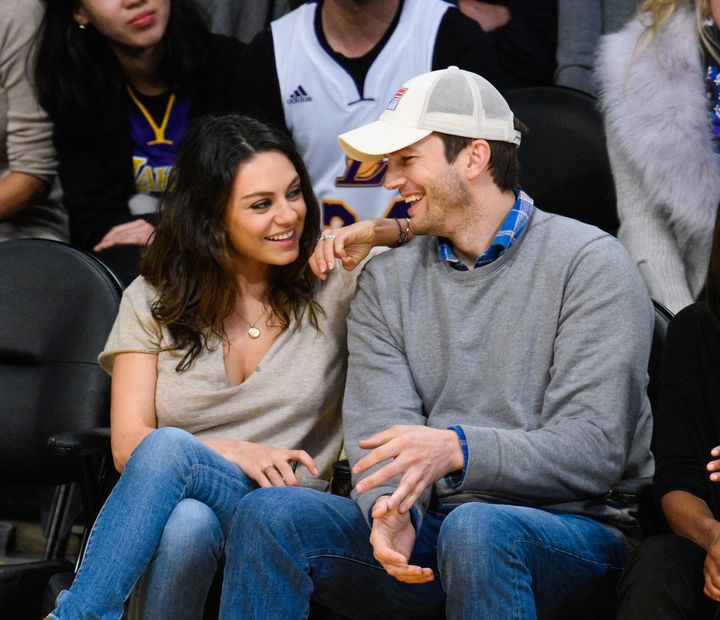 Mila Kunis (L) and Ashton Kutcher attend a basketball game between the Oklahoma City Thunder and the Los Angeles Lakers at Staples Center on December 19, 2014 in Los Angeles, California.