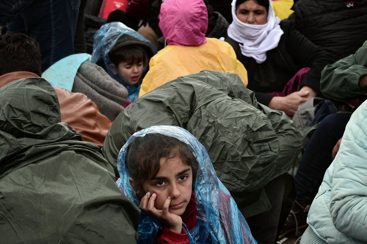 A child waits to cross from Greece into Macedonia on March 4, 2016. Frustrated refugees and migrants staged pr