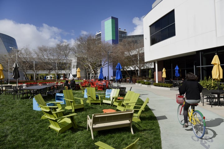 A cyclist rides past Google Inc. offices inside the Googleplex headquarters in Mountain View, Calif.