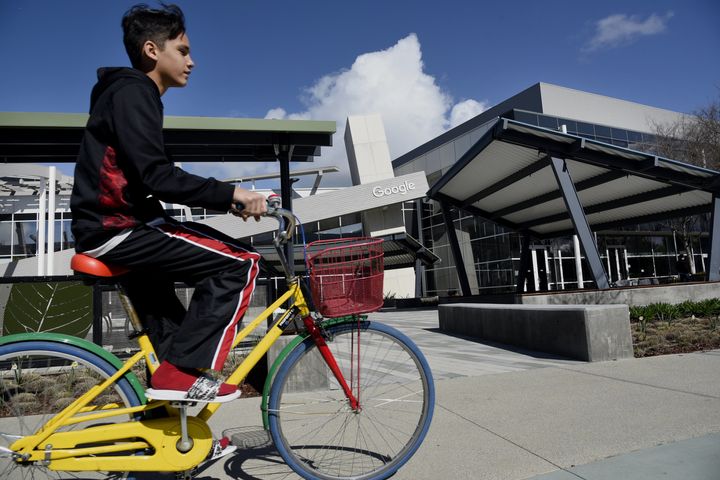 A cyclist rides past Google Inc. offices inside the Googleplex headquarters in Mountain View, Calif.