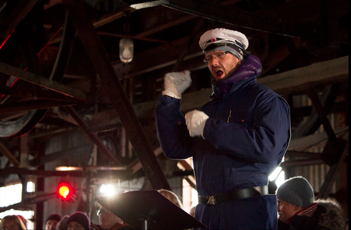 White gloves, blue overalls and a hammer and pick belt buckle are part of the choir's uniform.