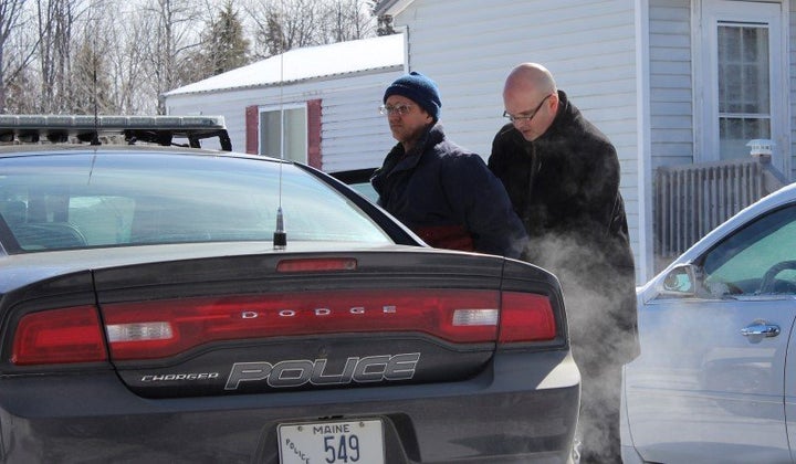 Maine State Police detectives pictured taking Philip Scott Fournier, left, into custody for the 1980 murder of Joyce McLain.