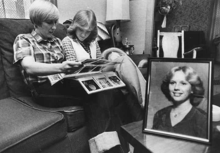 With a photo of Joyce McLain, who was murdered, in the foreground, mother Pamela McLain and sister Wendy leaf though the family album in their East Millinocket home in Sept. 1980.