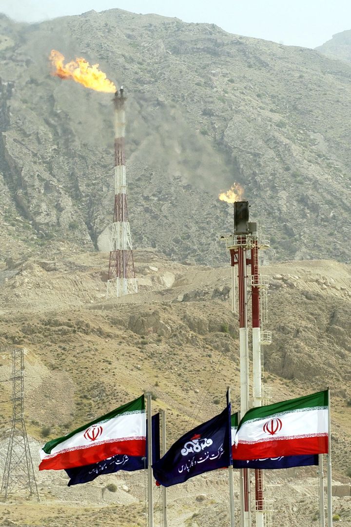 Zanjani has boasted of amassing a fortune of $10 billion, along with debts of a similar scale, while arranging billions of dollars of oil deals. Iranian national flags and flags of Iran's national oil company are seen in southwestern Iran.