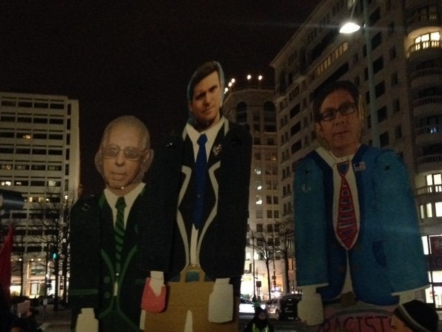 Protesters outside the white nationalist conference held puppets of the conference's three speakers (from left to right): Kevin MacDonald, Richard Spencer and Paul Ramsey.