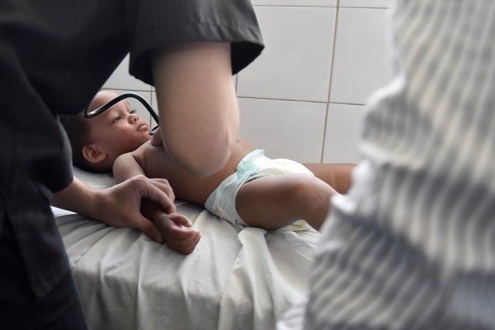 VENEZUELA, CARACAS - FEBRUARY 04: Juan Carlos Pena (1) with a rash and other symptoms of Zika Virus is examined by a doctor in a hospital at Petare slum, a suspected area of Zika virus propagation, at east of Caracas, Venezuela on February 4, 2016.