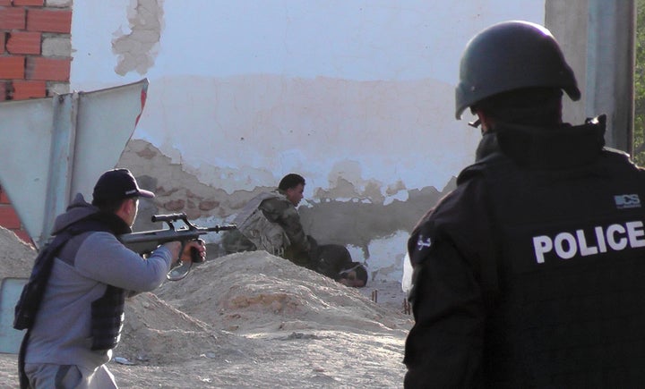 Tunisian forces check the body of a militant killed during clashes in the southern town of Ben Guerdane, near the Libyan border, March 7, 2016.