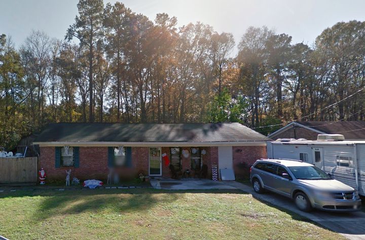 Police say the bodies of two men were found buried behind this South Carolina home.