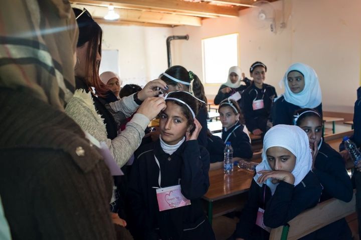 Members of the Malala School Choir prepare to perform as part of International Women's Day festivities.