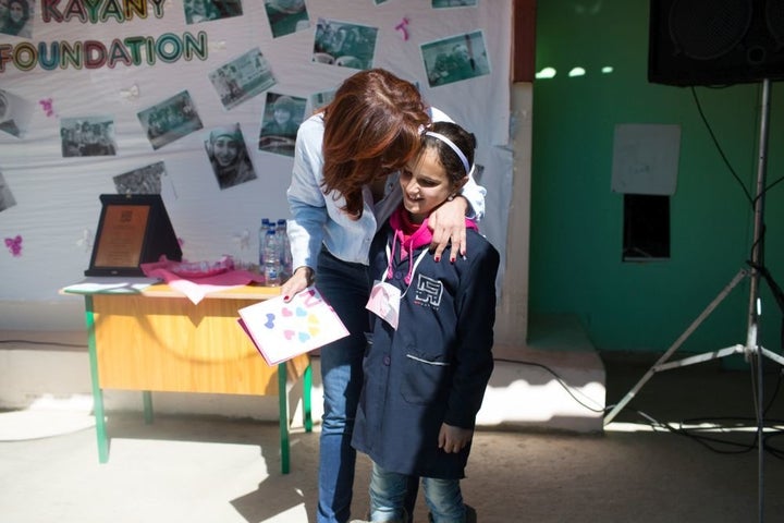 Nora Jumblatt embraces a student at the Malala School on March 7, 2016.