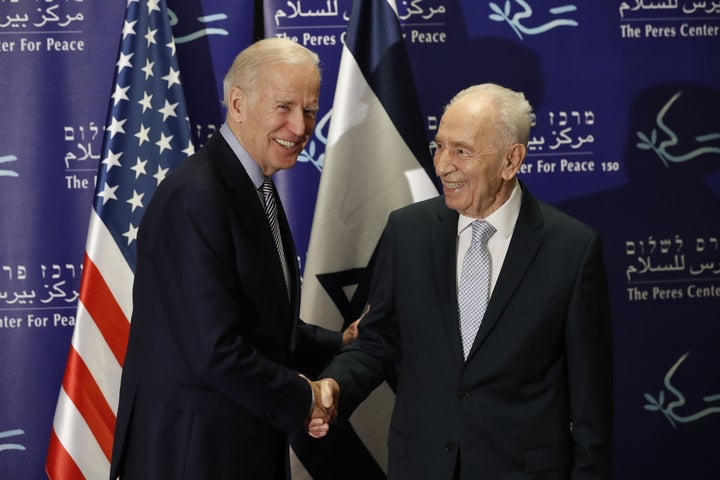 U.S. Vice President Joe Biden shakes hands with former Israeli president Shimon Peres in Tel Aviv on Tuesday. Biden arri