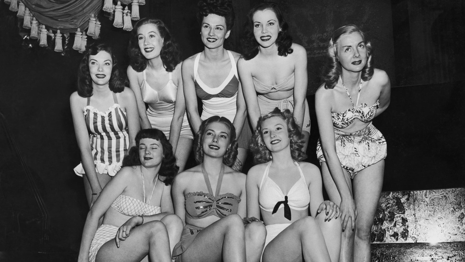 Young women dress up in floor length gowns, sparkling bikinis, and all the ...