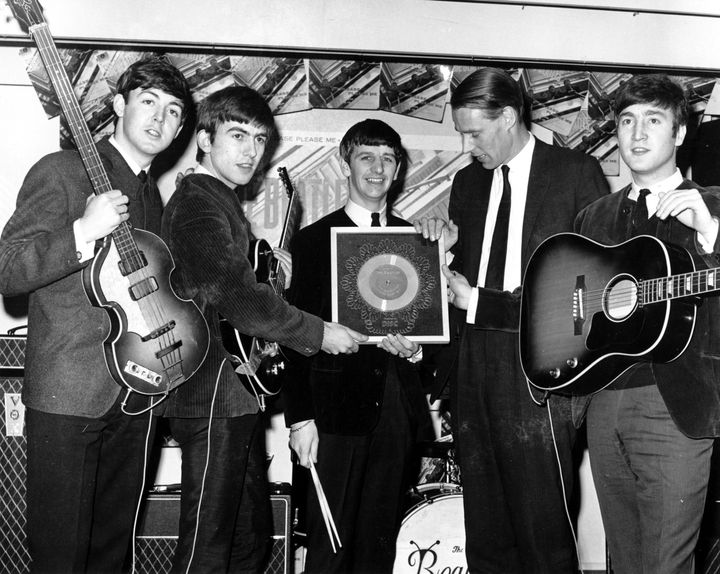 Rock and roll band 'The Beatles' poses for a portrait with their producer George Martin. (L-R) Paul McCartney, George Harrison, Ringo Starr, producer George Martin, John Lennon.