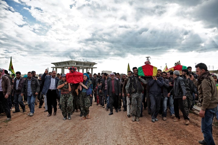 On April 14, 2015, a group of YPJ and YPG (People's Protection Unit) fighters carry the coffins of Kurdish fighters who were killed during clashes with the Islamic State in eastern frontline of Kobane, Syria.