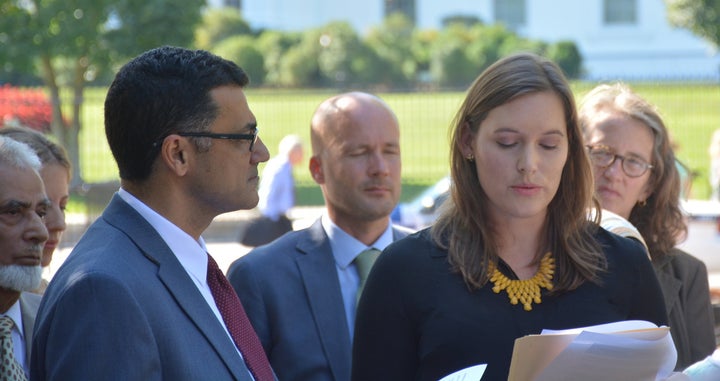 Catherine Orsborn (right) speaks at a press conference on the Syria conflict and the refugee crisis in front of the White House in Sept. 2015.