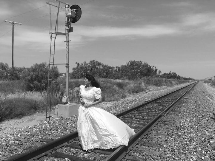 Herrera strikes a pose on a train track.