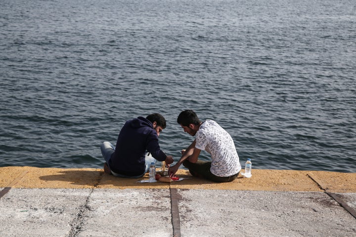 A volunteer named Christina, who owns a bakery in central Athens, regularly brings hot loaves of bread to the port.