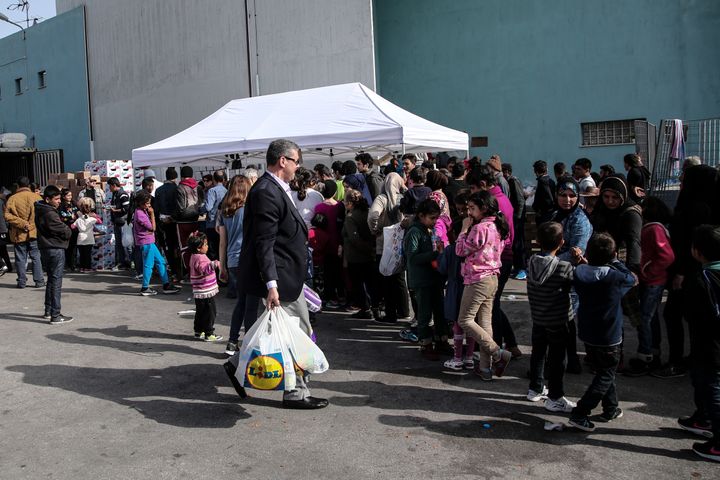 Dozens of volunteers hand out food, clothing and medical aid to travelers in PIraeus.