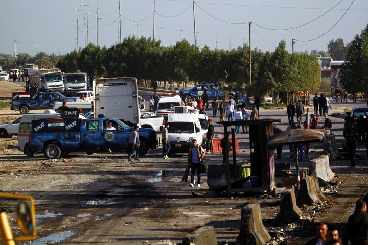 One of the files, labeled "Martyrs," detailed Islamic State members willing and trained to carry out suicide attacks. People inspect the site of a suicide bomb blast in Hilla, Iraq, for which the Islamic State group claimed responsibility.