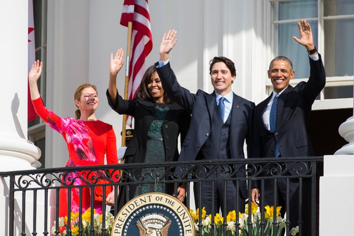 President Barack Obama (R) and Canadian Prime Minister Justin Trudeau (2nd R), U.S. first lady Michelle Obama (2nd L) and Sophie Grégoire-Trudeau wave to invited guests from the Truman Balcony of the White House after an arrival ceremony at the White House, March 10, 2016 in Washington, D.C.