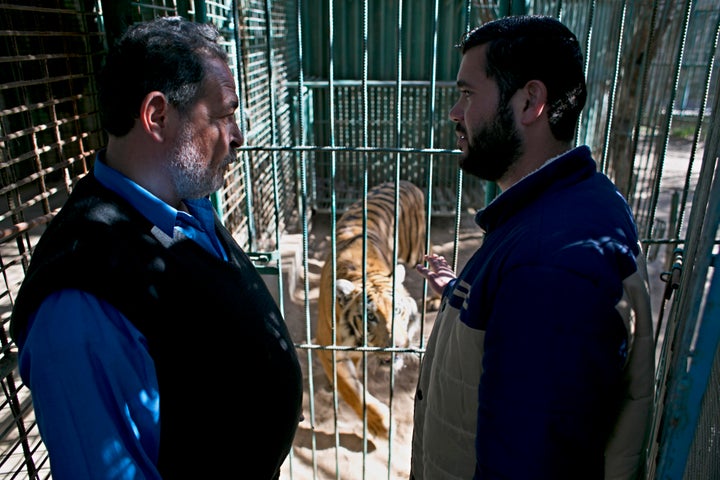 Zoo owner Mohammad Oweida, right, is trying to sell his tiger to reclaim some of his lost profits.