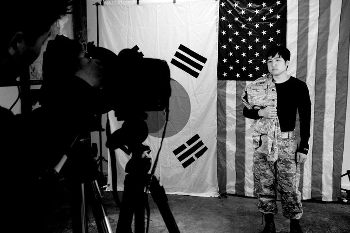 Zeke Anders photographs a KAD diaries subject in front of the American and South Korean flags in Washington, D.C.
