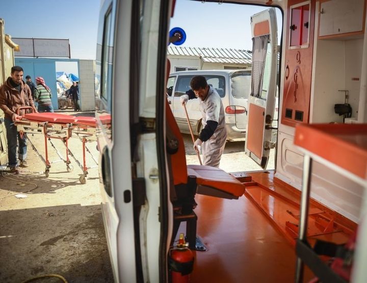 Medics from the Bab al Salama Hospital clean an ambulance on call at the border hospital and prepare for the next sortie during the northern Aleppo offensive. As one of the largest hospitals in the province, the Bab al Salama Hospital runs a fleet of ambulances and prioritizes surgical operations for the region's war-wounded.