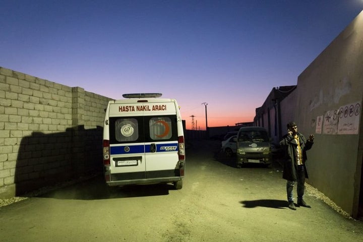 An ambulance rushes to transport a Syrian patient injured in a barrel bomb attack in Aleppo to a Turkish state hospital across the border.