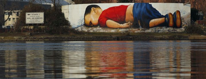 A huge mural painting showing Syrian tot Aylan Kurdi on the Main River in Frankfurt.