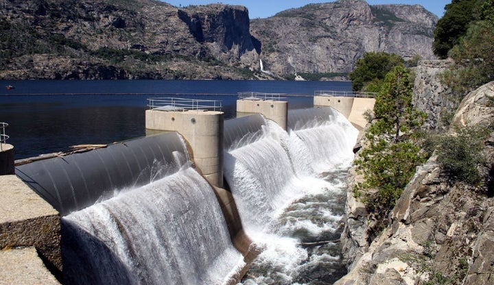 Water overflows from the dam at Hetch Hetchy reservoir, one of the main reservoirs in the San Francisco Public Utilities Comm