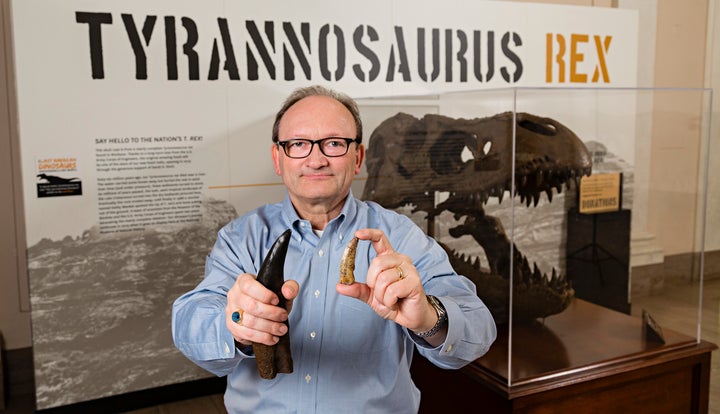 Hans Sues, chair of the paleobiology department at the National Museum of Natural History, Smithsonian Institution, hold