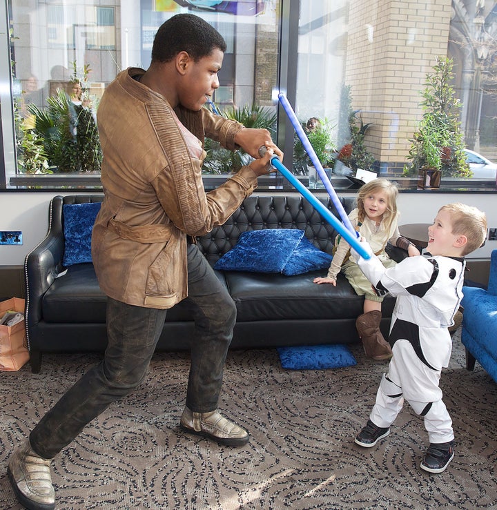 John Boyega and Daniel show off their lightsaber skills. 