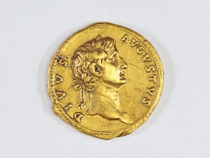 One side of the coin depicts Augustus, the founder of the Roman empire who ruled from 27 B.C. until his death in A.D. 14.