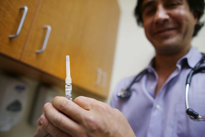 Dr. Sassan Naderi holds a vile of flu vaccination at the Premier Care walk-in health clinic on January 10, 2013 in New York City.