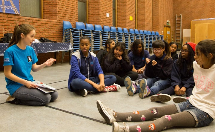 Girlguiding peer educators talking to younger members