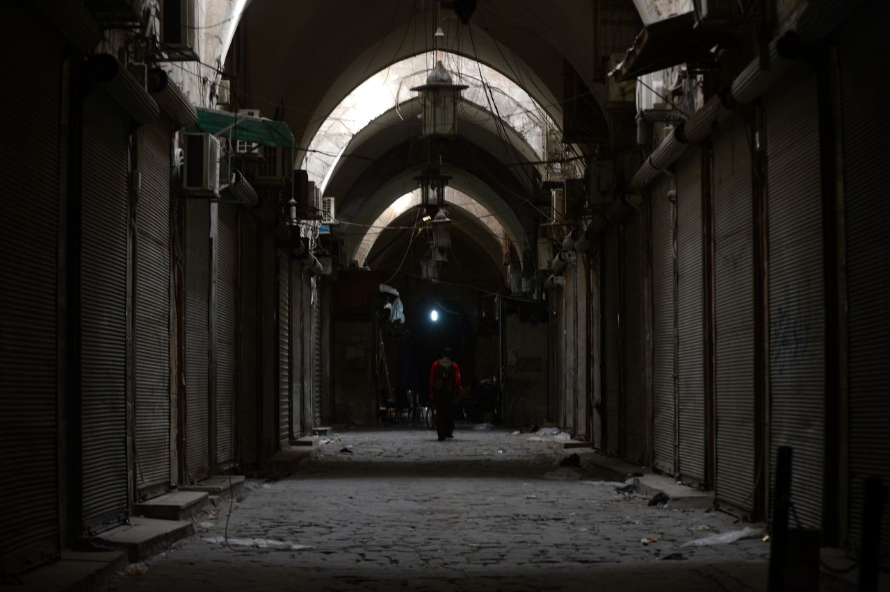 A Syrian man walks in a deserted alley in Aleppo's Old city on October 11, 2012