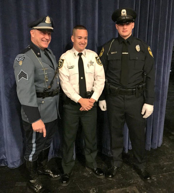 Deputy John Robert Kotfila Jr. poses with his father, Massachusetts State Police Sgt. John R. Kotfila Sr., left, and his brot