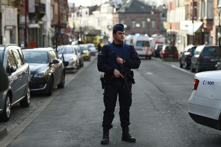 A police officer stands near the site of a shooting on Dries-Driesstraat at Forest-Vorst in Brussels on March 15, 2016